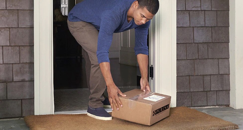 A man receives his Pro Plan Vet Direct order at his doorstep.