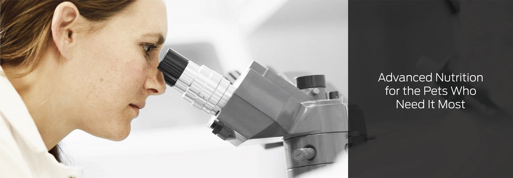 A scientist looking in a microscope with the text: Advanced Nutrition for the Pets Who Need It Most.