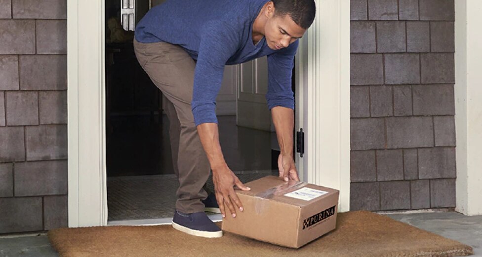 A man receives his Pro Plan Vet Direct order at his doorstep.