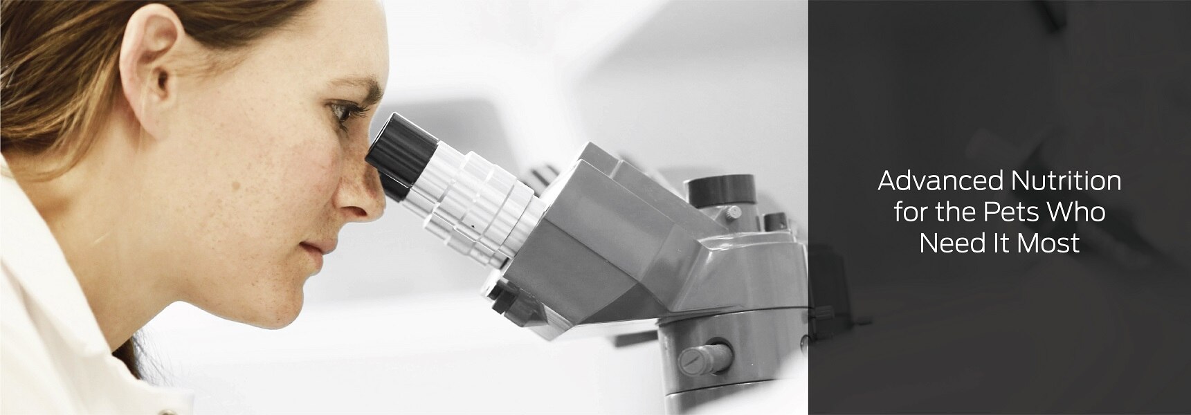 A scientist looking in a microscope with the text: Advanced Nutrition for the Pets Who Need It Most.